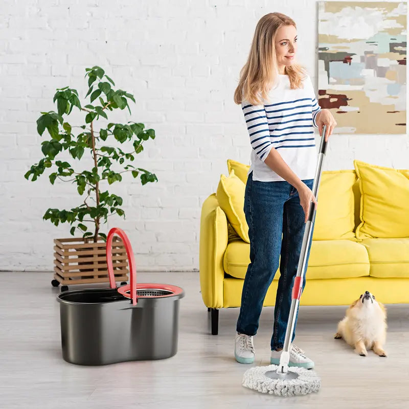 Woman cleaning a room with a mop, yellow couch, and plant in the background
